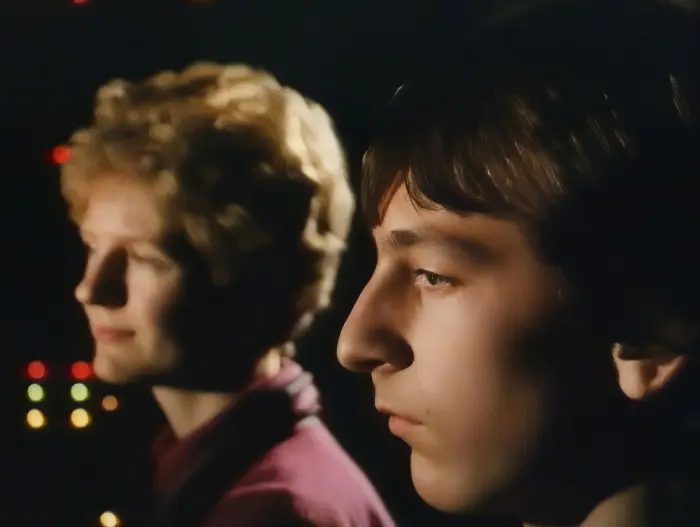 Emma Tumim and David Portsmouth in a scene from Pictures in the Mind. They are watching a film about her oralist education and how oralism badly affects deaf childrens' education and development.