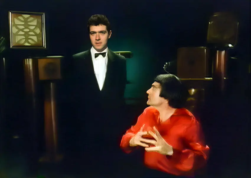 This scene shows comedian John Sessions and Doug Alker in a 'Milan 1880' setting. The scene introduces John Sessions as a manic oralist bent on overseeing the decimation of the deaf and their sign language culture. In scenes that follows John truly gets to show the shocking attitudes the oralists had towards the deaf.