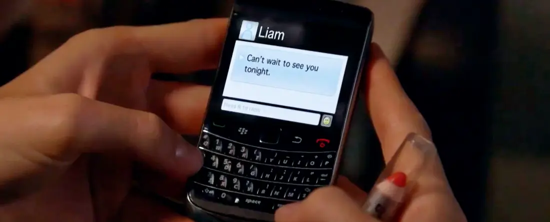 Picture of a Blackberry phone with words on the screen saying 'Can't wait to see you tonight.'