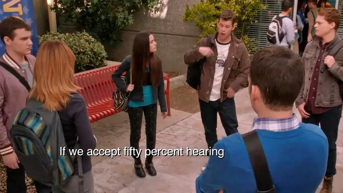 The Carlton Deaf crew discuss whether the school can accept 50% more hearing. The subtitles say 'If we accept fifty percent hearing...'